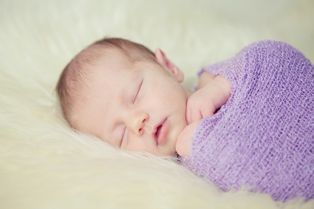 portrait of baby in purple swaddle wrap - baby photography Edenbridge