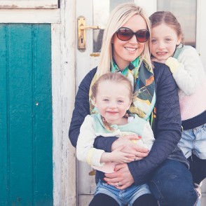 Portrait of Mum with her daughters on Seasalter beach Kent