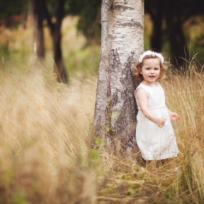 Pretty little girl in white dress standing by tree - child portrait photography Tunbridge Wells
