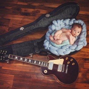 Stunning portrait of baby posed in guitar case - Newborn Baby Photography Maidstone Kent