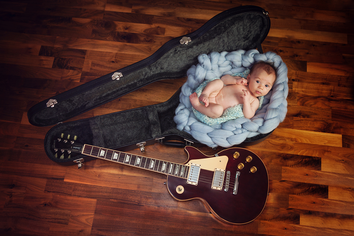 Stunning portrait of baby posed in guitar case - Newborn Baby Photography Maidstone Kent